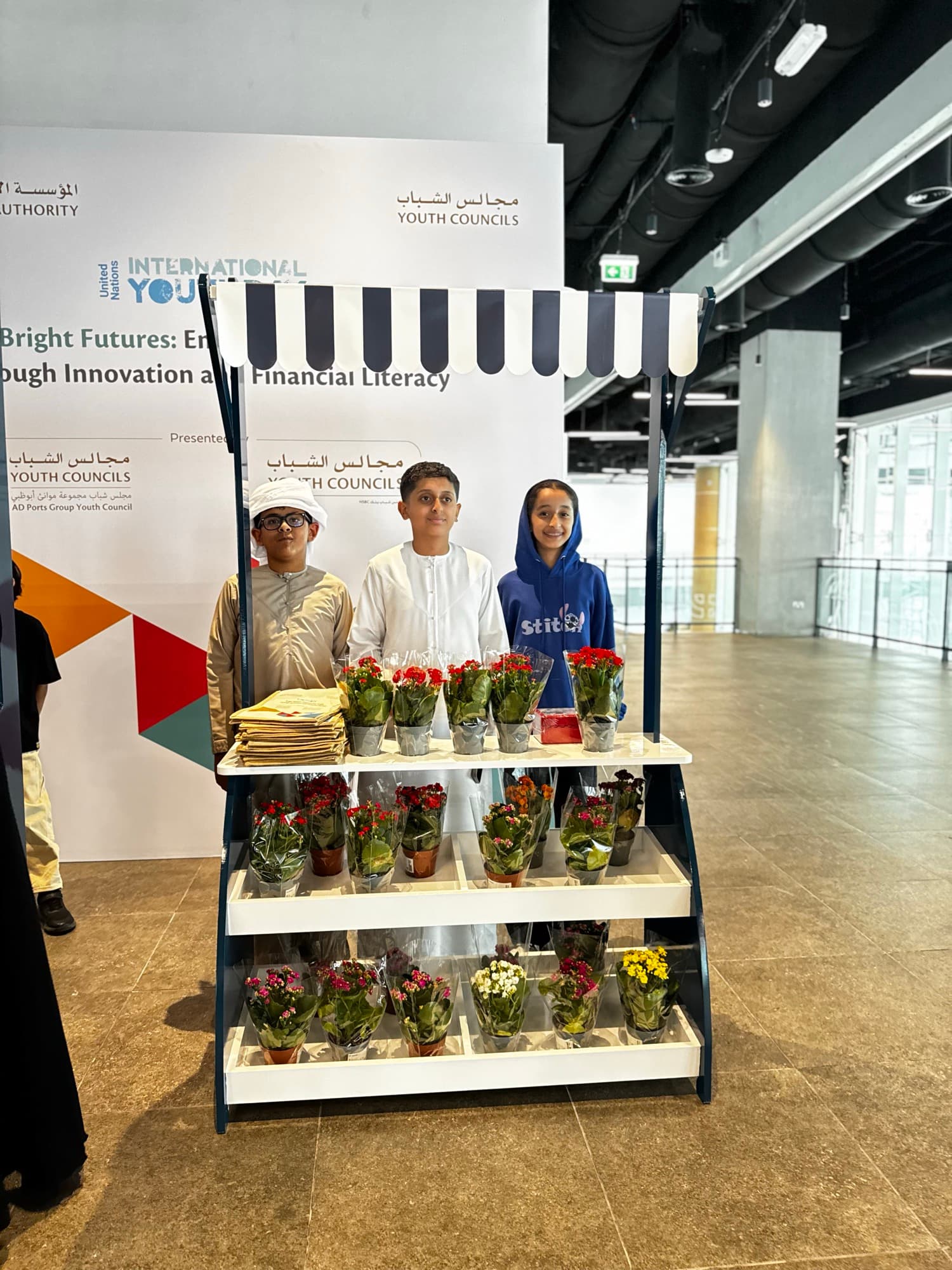 Young entrepreneurs selling plants at their own pop-up stall