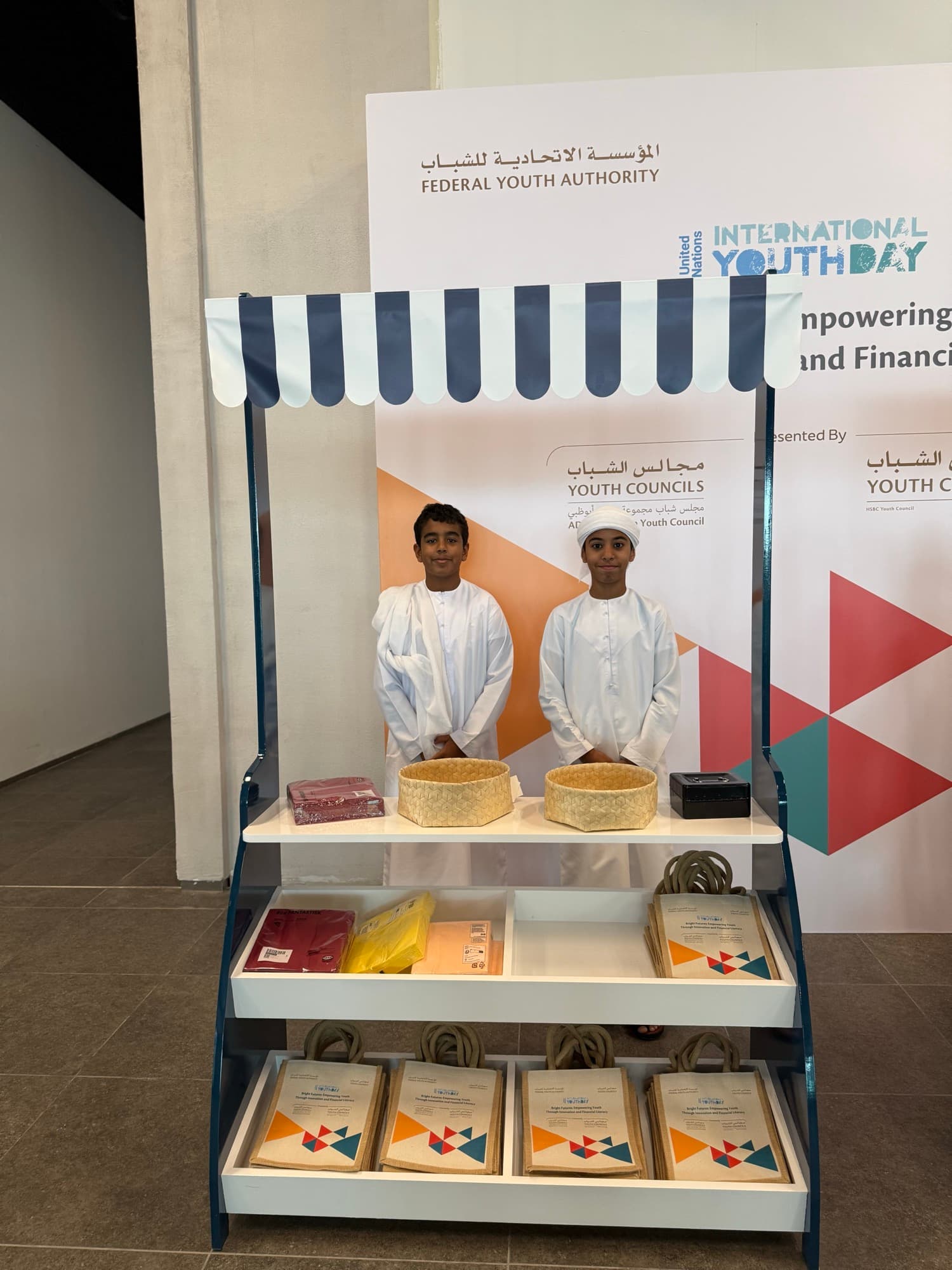 Two boys presenting their handmade products at a youth enterprise stall